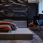 Stylish hotel room with a modern double bed and elegant interior design, perfect for relaxation.
